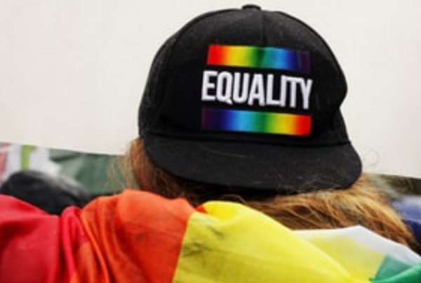 Back of a black hat with the word Equality in white bold text and rainbow stripe above and below