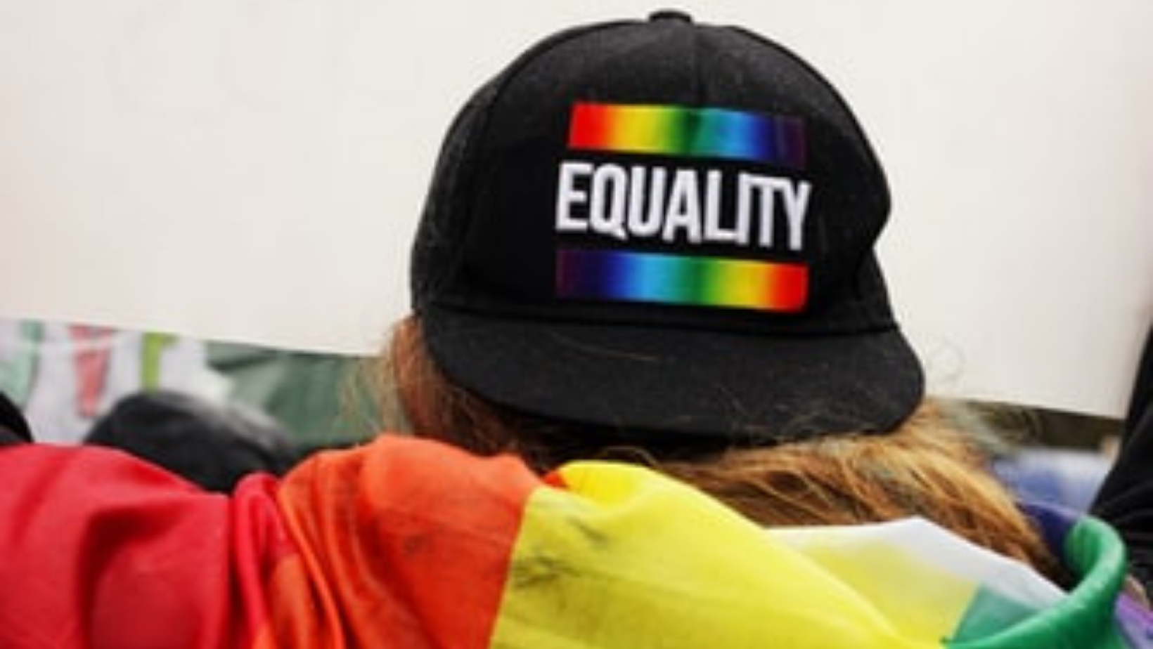 Back of a black hat with the word Equality in white bold text and rainbow stripe above and below